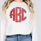 a woman wearing a white sweatshirt with a red polka dot monogrammed monogram
