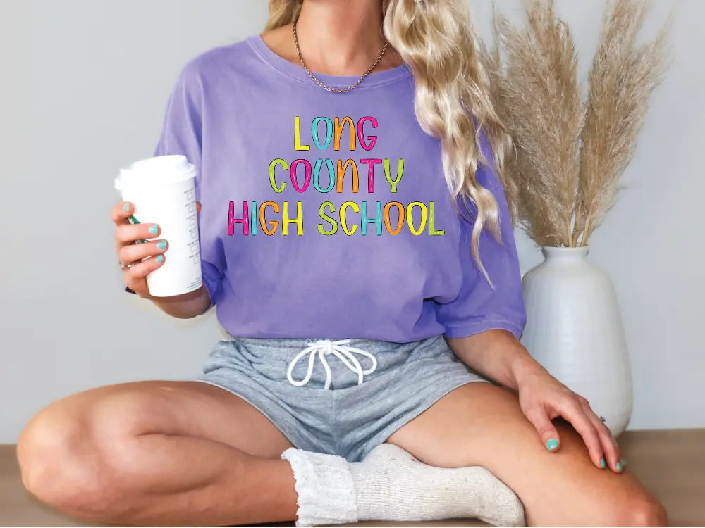 a woman sitting on a table holding a cup of coffee