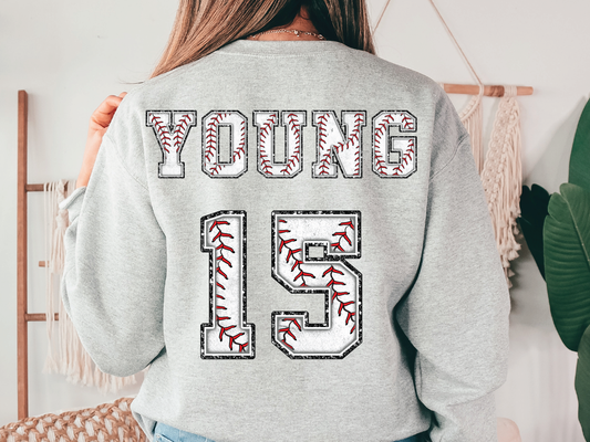 a young girl wearing a sweatshirt with the number fifteen printed on it