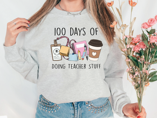 a woman wearing a sweatshirt that says 100 days of doing teacher stuff