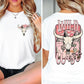 a woman wearing a white shirt with a cow skull on it