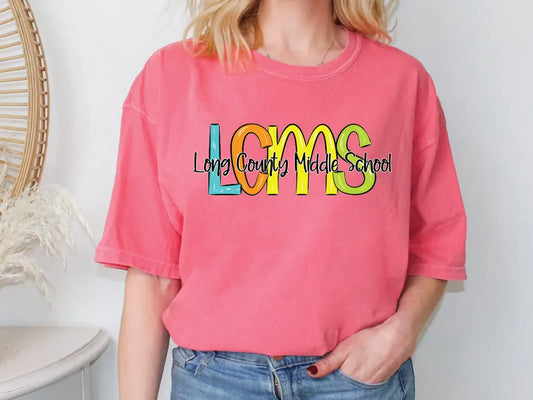 a woman wearing a pink shirt with the words looms on it