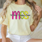 a woman sitting on a bed wearing a t - shirt that says mcs