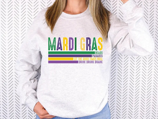 a woman wearing a sweatshirt that says mardi gras