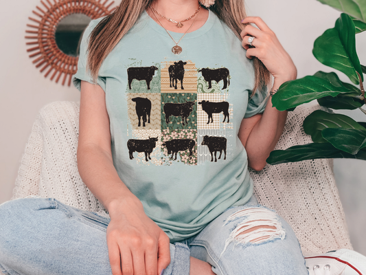 a woman sitting on a couch wearing a t - shirt with cows on it
