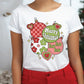 a woman wearing a white t - shirt that says merry christmas