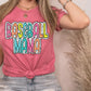 a woman wearing a pink tshirt with the words baseball mom on it